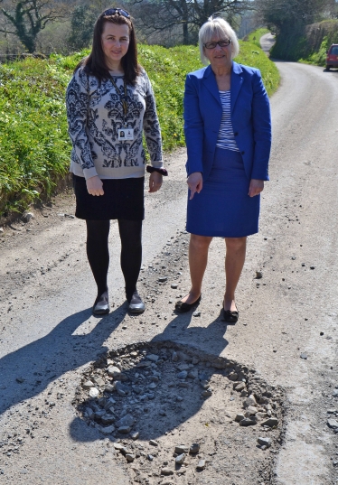Sheryll Murray MP with Cllr Benedicte Jenkinson share their concern over a pothole during a previous campaign.